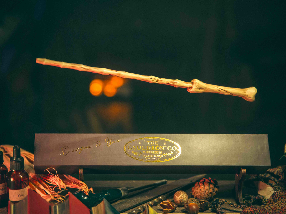 Dragon & Yew Magic Wand levitating above its box, ideal for wizards exploring the shadows of magic