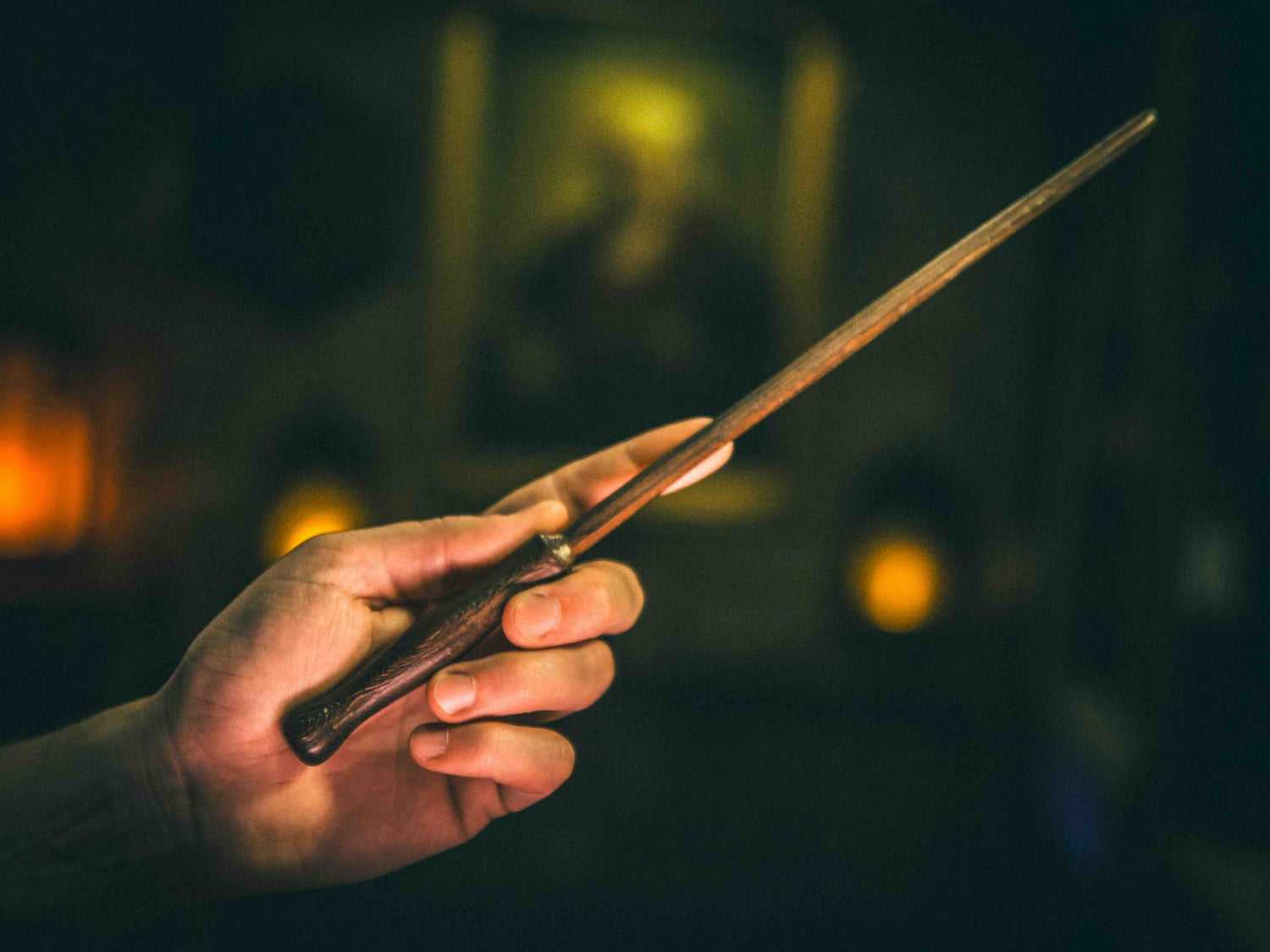 Dragon & Oak Magic Wand being held by a wizard, symbolizing strength, resilience, and grounding magical power.