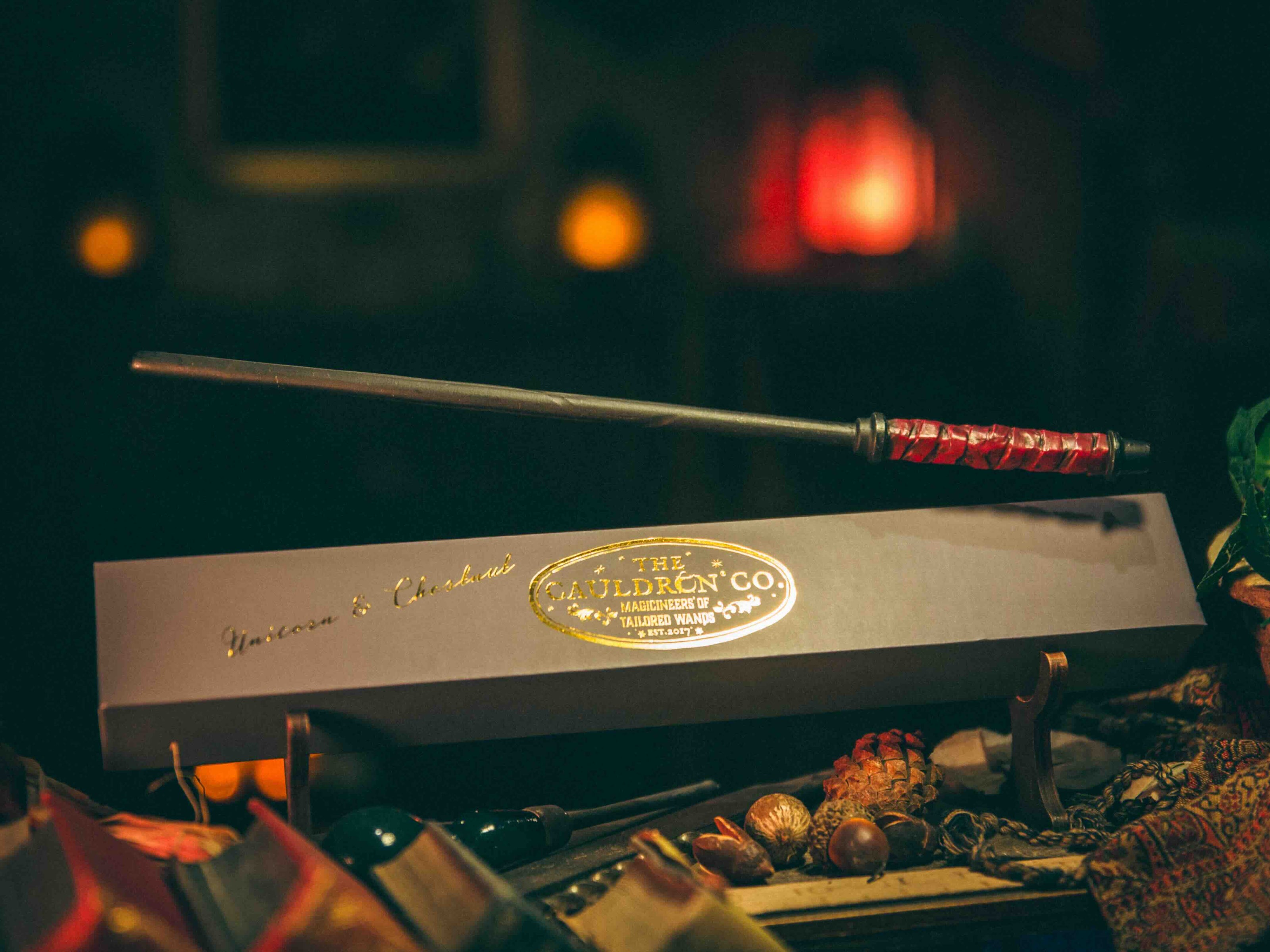 Unicorn & Chestnut Magic Wand floating above its box, exuding magical energy and resilience
