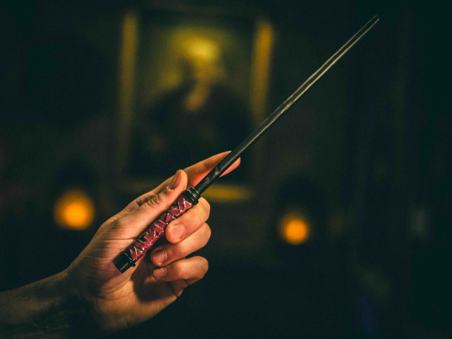 Unicorn & Chestnut Magic Wand being held by a wizard, symbolizing resilience and bold magic for spellcasting.